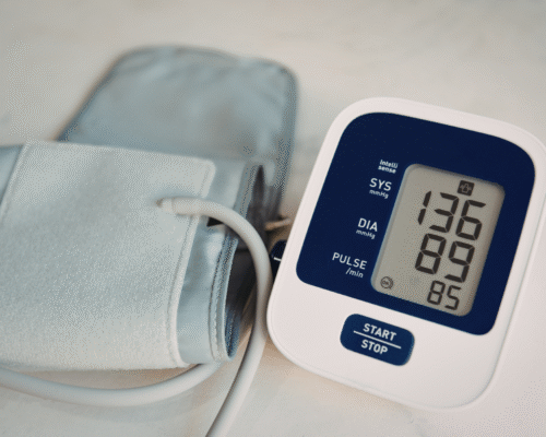 Digital blood pressure monitor and cuff displayed, representing injuries and claims related to defective medical devices in Colorado product liability cases.