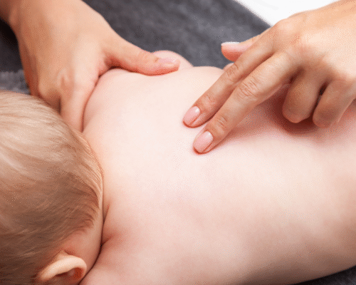 Healthcare provider examines a newborn’s back, illustrating potential spinal cord injury complications related to childbirth and maternal medical malpractice claims.