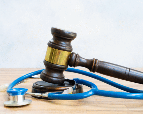 A judge’s gavel resting on a stethoscope, symbolizing the intersection of healthcare and the legal system in cases involving hospital-acquired infections and medical negligence.