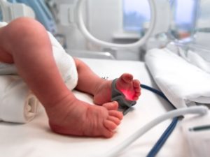 A close up of a babies legs in the NICU