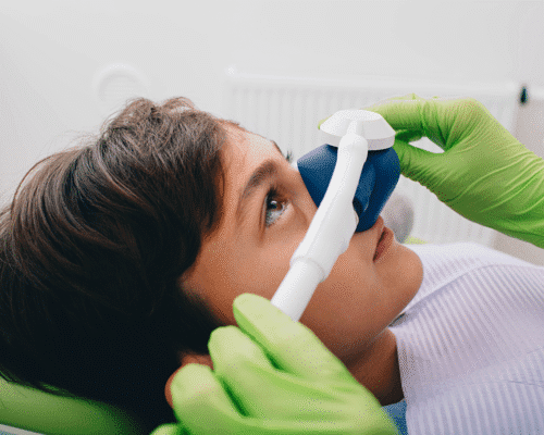 Child receiving dental sedation with monitoring equipment in a clinical setting, illustrating potential risks and malpractice concerns in pediatric dental sedation cases in Denver.